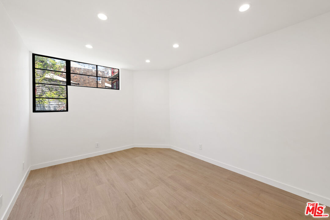 29233 Heathercliff Road, Unit 4 Malibu, CA 90265 - Photo 11 of 20 an empty room with wooden floor and windows