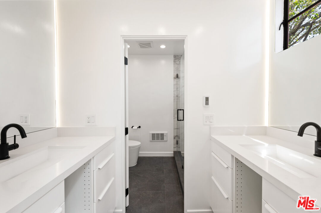 29233 Heathercliff Road, Unit 4 Malibu, CA 90265 - Photo 13 of 20 a bathroom with a sink and a mirror