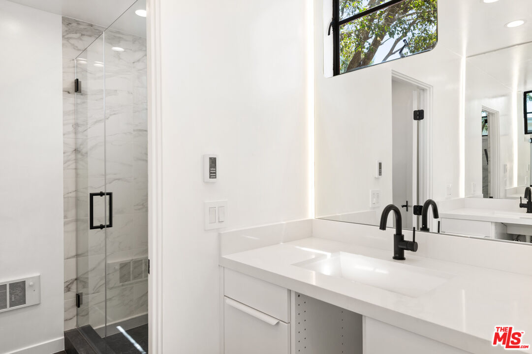 29233 Heathercliff Road, Unit 4 Malibu, CA 90265 - Photo 14 of 20 a bathroom with a sink and a mirror