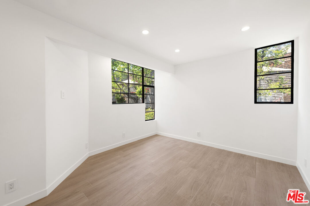 29233 Heathercliff Road, Unit 4 Malibu, CA 90265 - Photo 16 of 20 an empty room with windows and closet