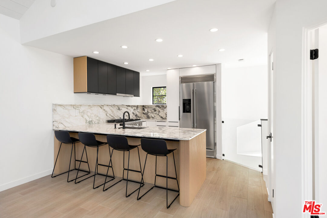 29233 Heathercliff Road, Unit 4 Malibu, CA 90265 - Photo 7 of 20 a living room with stainless steel appliances kitchen island granite countertop furniture a sink and a large mirror
