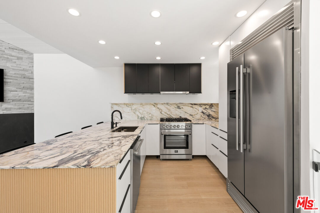 29233 Heathercliff Road, Unit 4 Malibu, CA 90265 - Photo 8 of 20 a kitchen with granite countertop a sink stainless steel appliances and cabinets