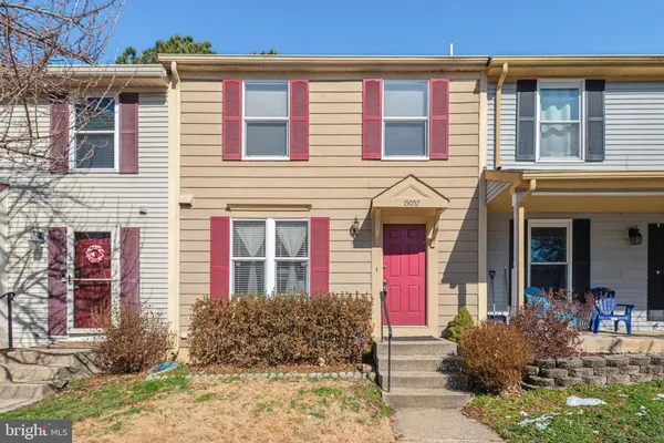 front view of a brick house with a yard