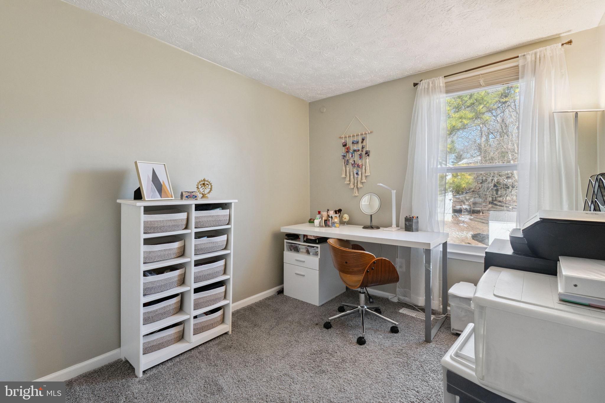 15057 Mill Spring Drive Dumfries, VA 22025 - Photo 14 of 21 a view of a workspace with furniture and a window