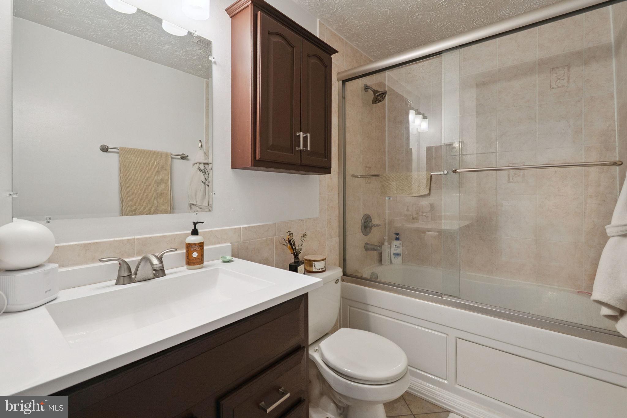 15057 Mill Spring Drive Dumfries, VA 22025 - Photo 16 of 21 a bathroom with a sink a toilet and shower