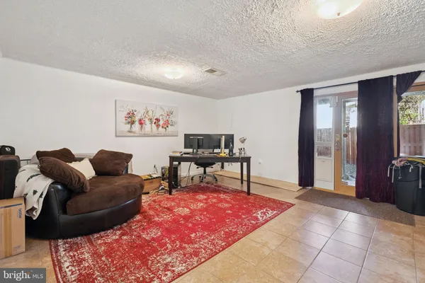 a living room with furniture rug and a piano