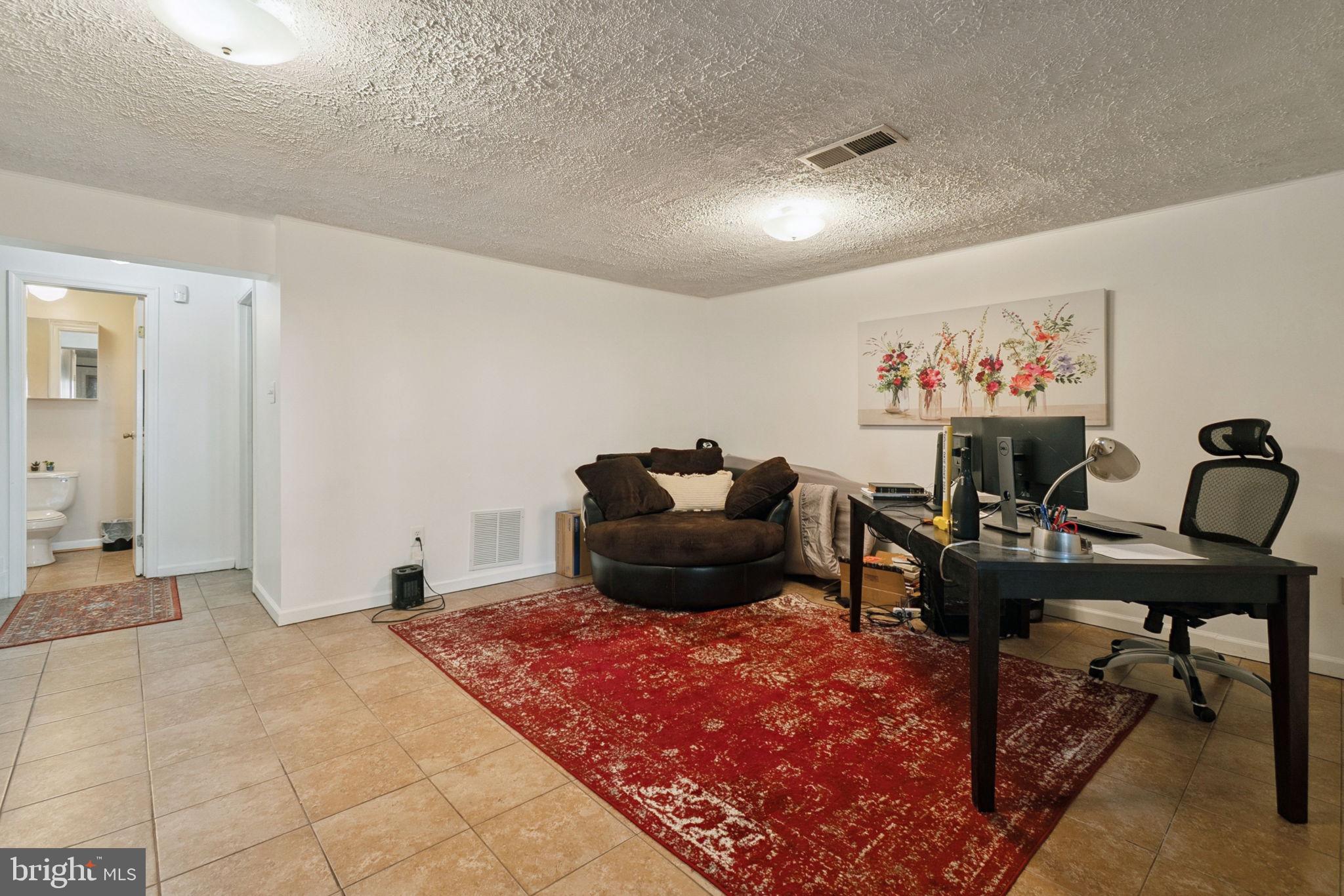 15057 Mill Spring Drive Dumfries, VA 22025 - Photo 18 of 21 a living room with furniture rug and a piano
