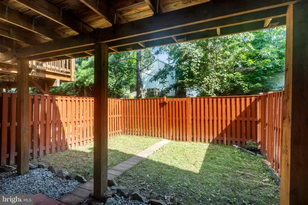 a view of a house with a wooden fence