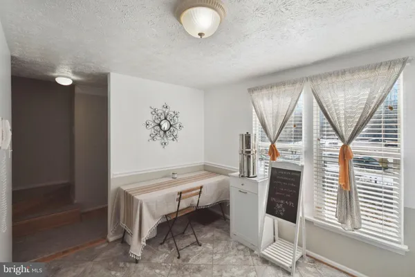 a living room with furniture a flat screen tv and a window