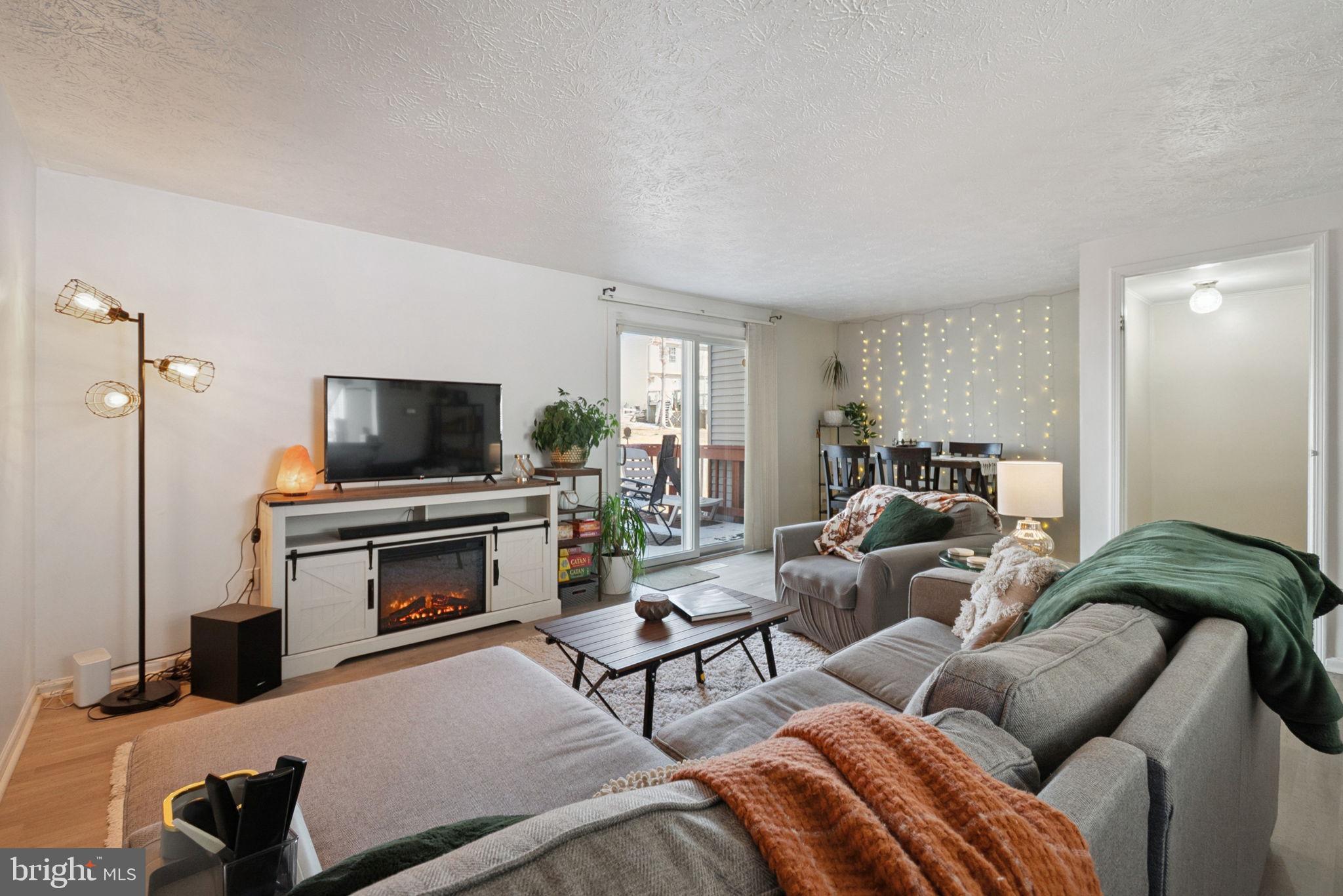 15057 Mill Spring Drive Dumfries, VA 22025 - Photo 7 of 21 a living room with furniture a flat screen tv and a window