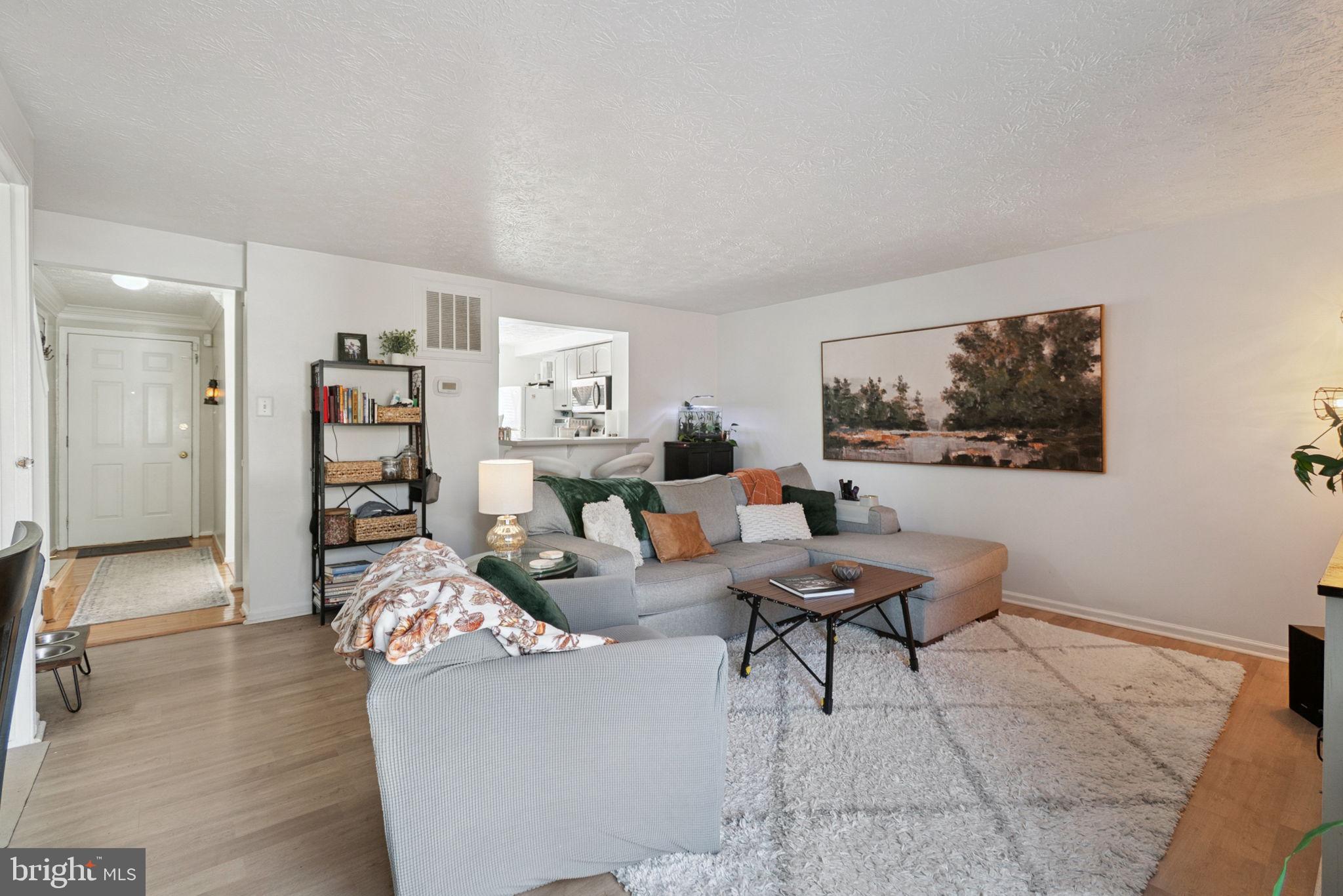 15057 Mill Spring Drive Dumfries, VA 22025 - Photo 8 of 21 a living room with furniture and a flat screen tv