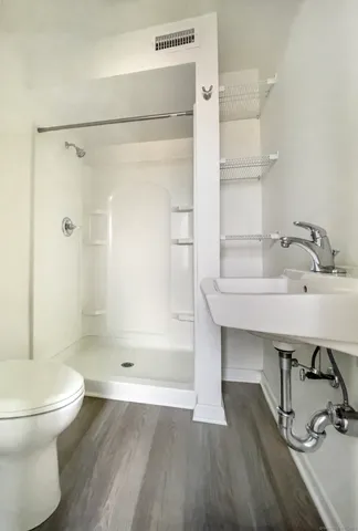 a bathroom with a sink toilet and shower