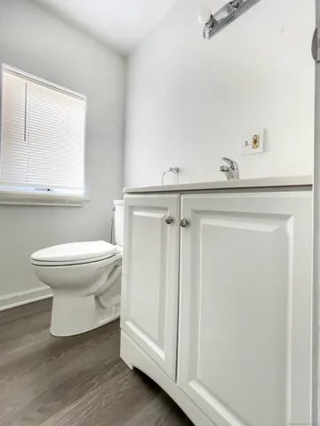 a white toilet sitting next to a bathroom sink