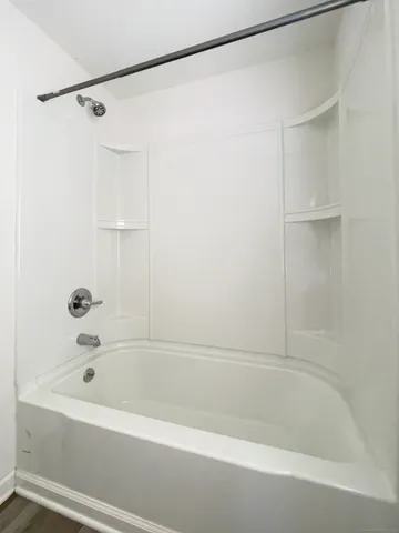 a bathroom with a shower and a bath tub