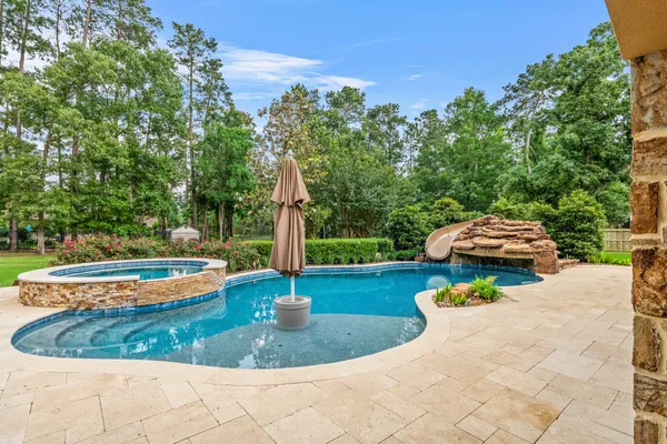 a view of a backyard with plants and patio