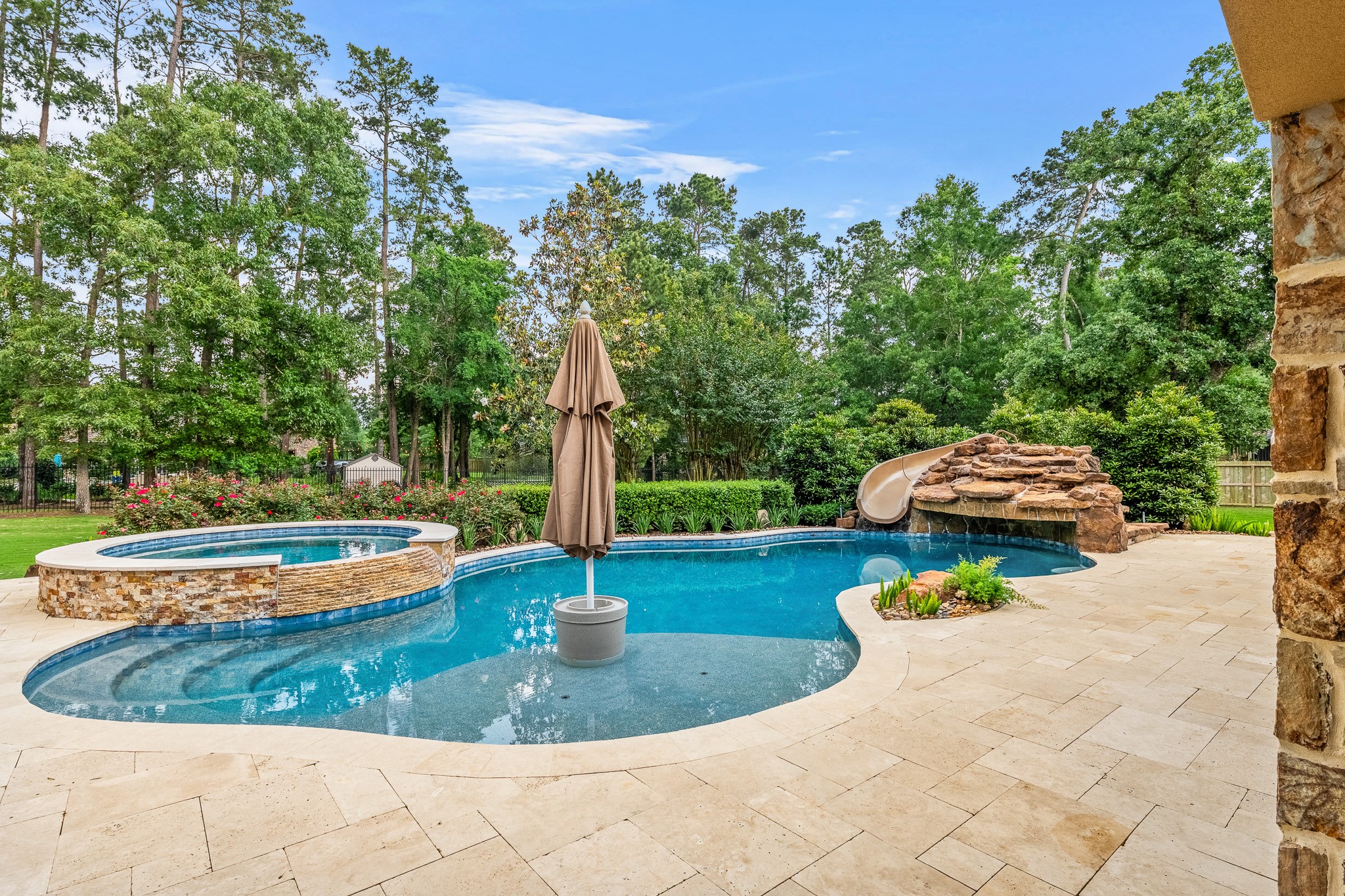 a view of a backyard with plants and patio