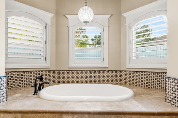 a bathroom with a granite countertop double vanity sink and a mirror