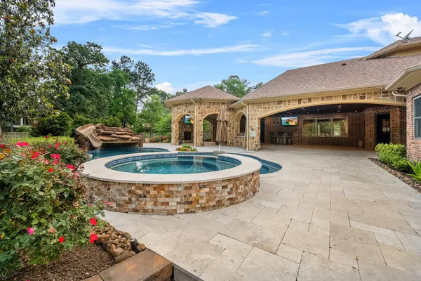 a view of a house with backyard porch and sitting area