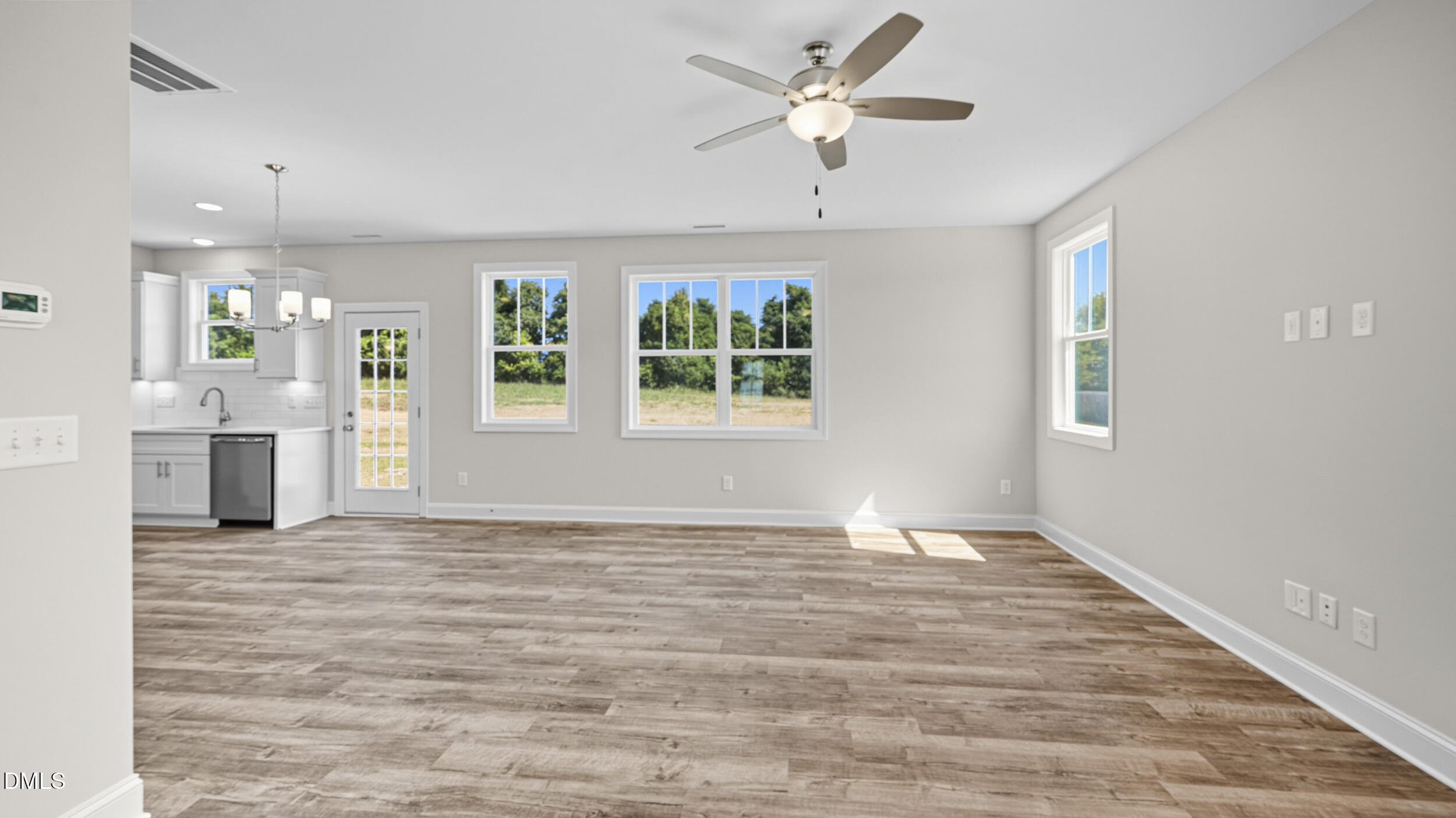 4105 Ralph Holt Court Snow Camp, NC 27349 - Photo 10 of 35 a view of an empty room with a window and wooden floor