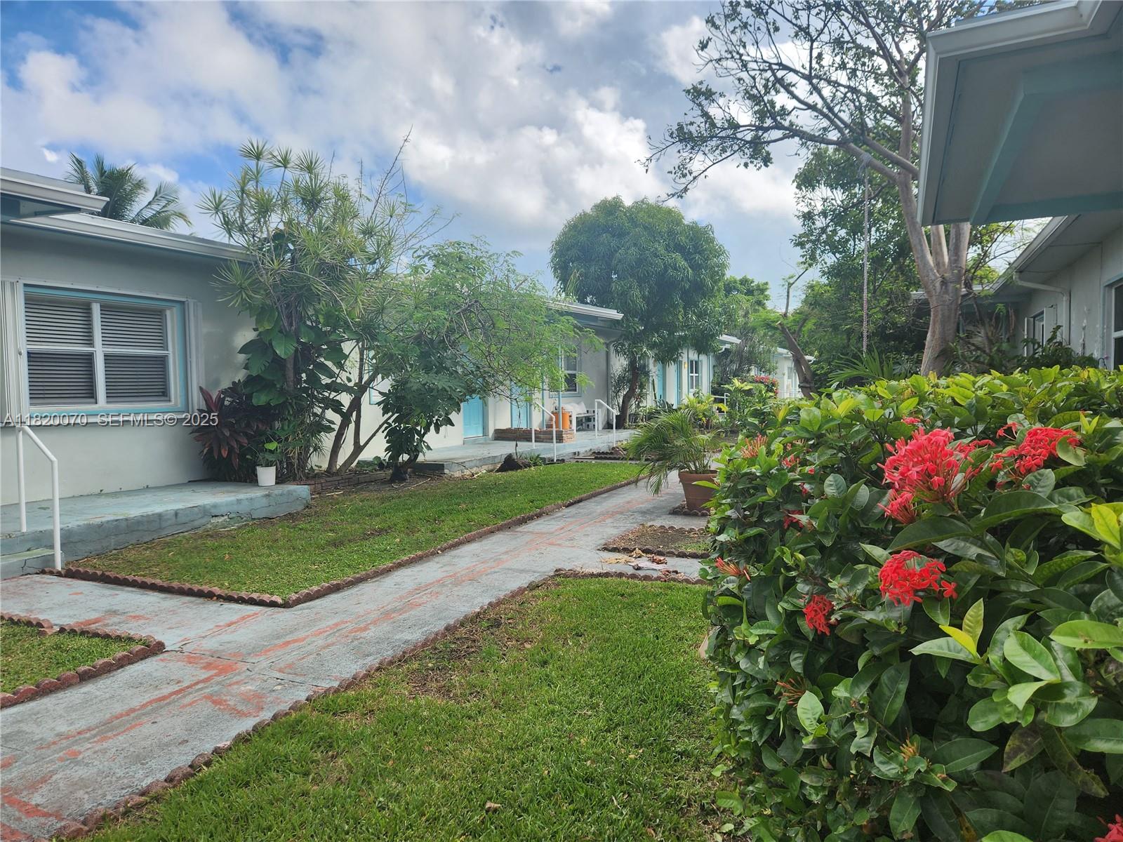 1239 Marseille Drive, Unit 4 Miami Beach, FL 33141 - Photo 1 of 15 a view of a house with a yard and garden