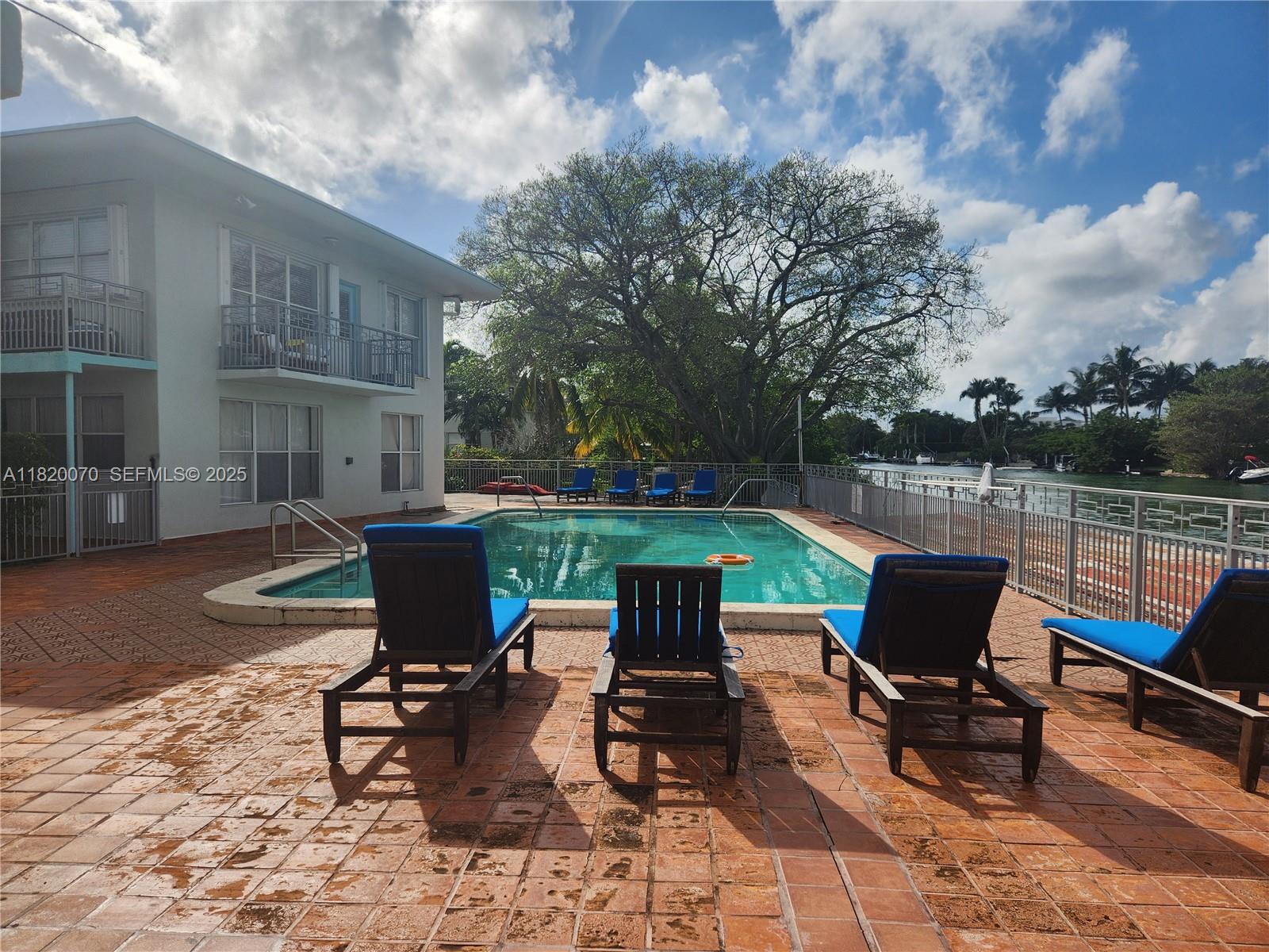 1239 Marseille Drive, Unit 4 Miami Beach, FL 33141 - Photo 2 of 15 a view of a chairs and table in the patio