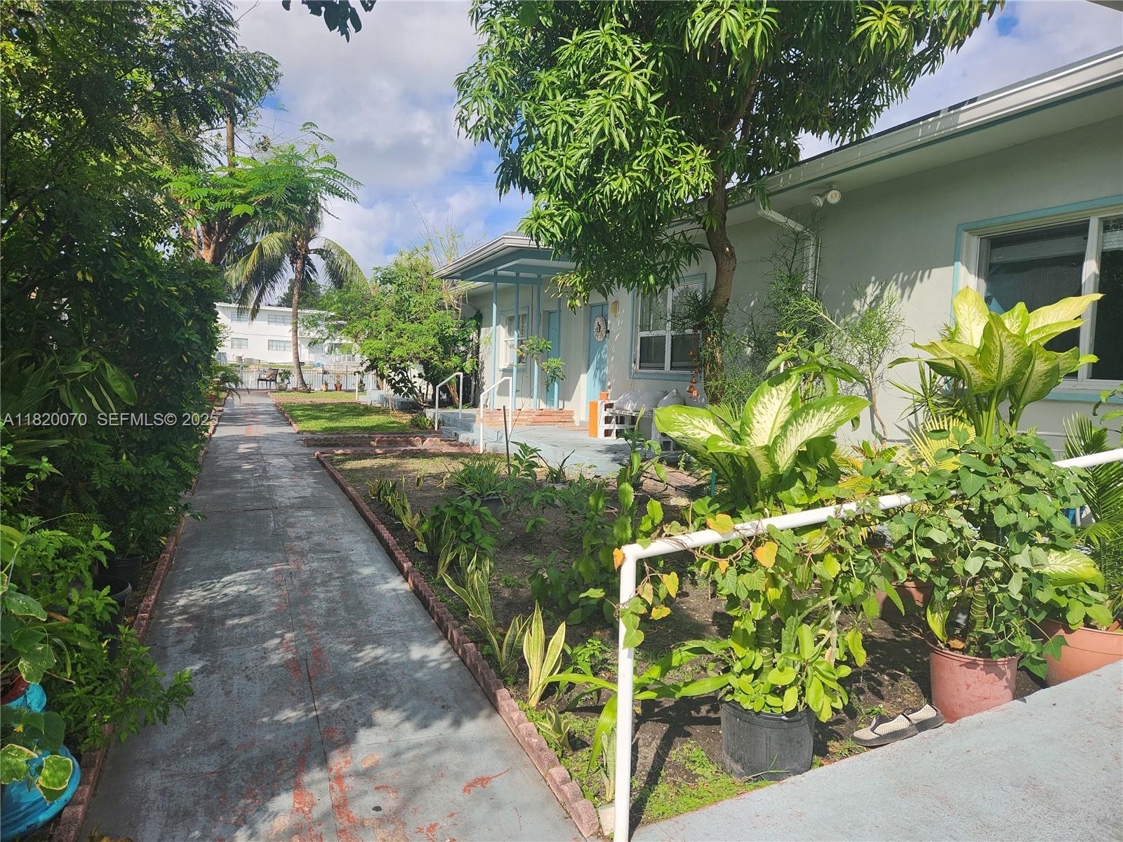 1239 Marseille Drive, Unit 4 Miami Beach, FL 33141 - Photo 4 of 15 a front view of a house with a yard