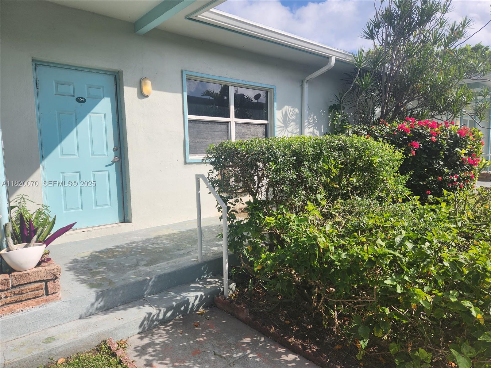 1239 Marseille Drive, Unit 4 Miami Beach, FL 33141 - Photo 6 of 15 a view of a house with a yard and potted plants