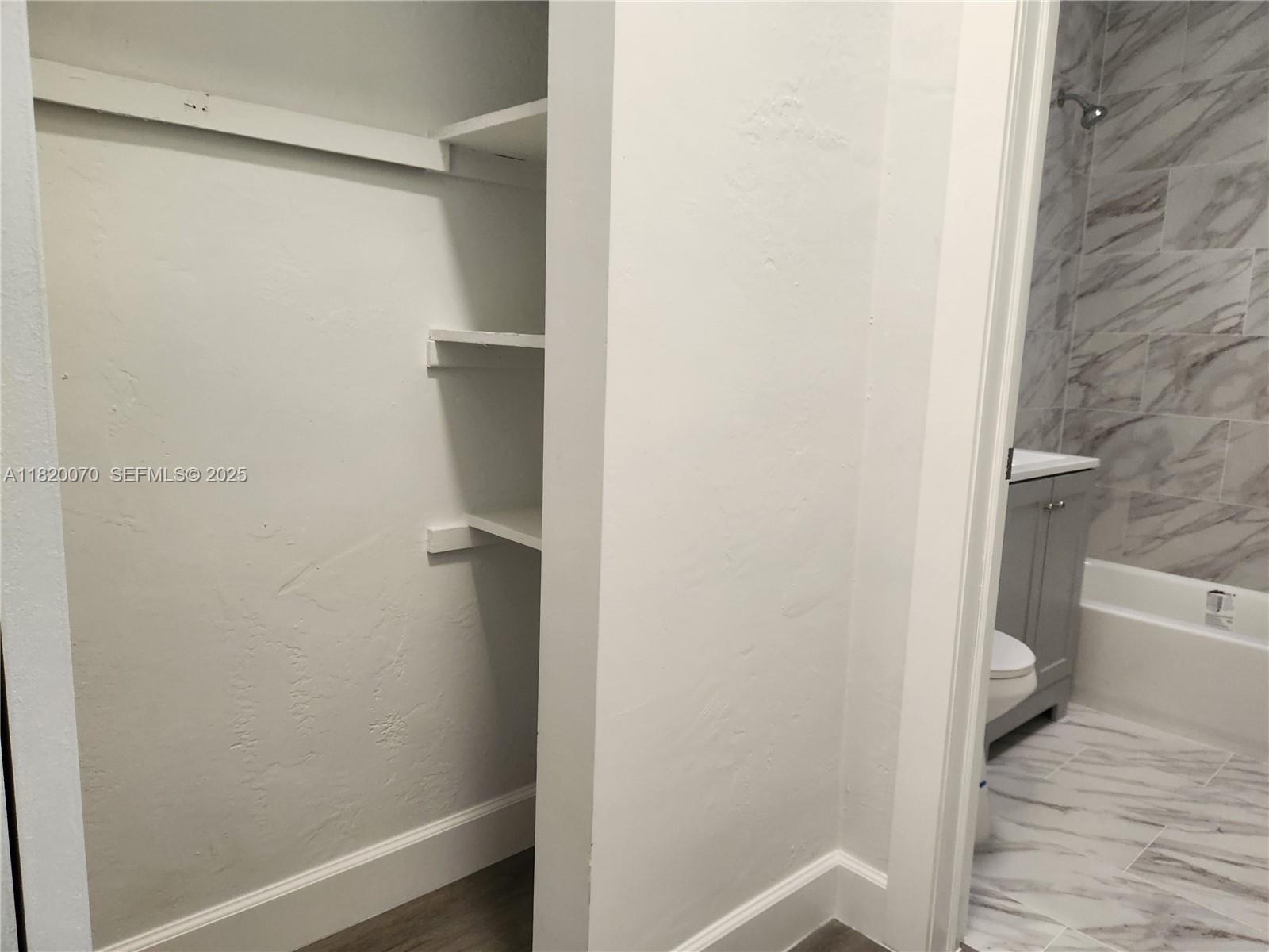 1239 Marseille Drive, Unit 4 Miami Beach, FL 33141 - Photo 8 of 15 a bathroom with a toilet and a shower