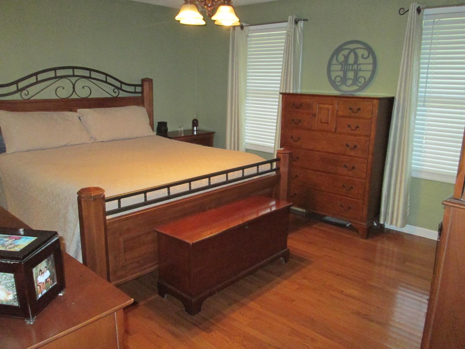 708 3rd Avenue West Springfield, TN 37172 - Photo 11 of 30 a bedroom with a bed and a chandelier