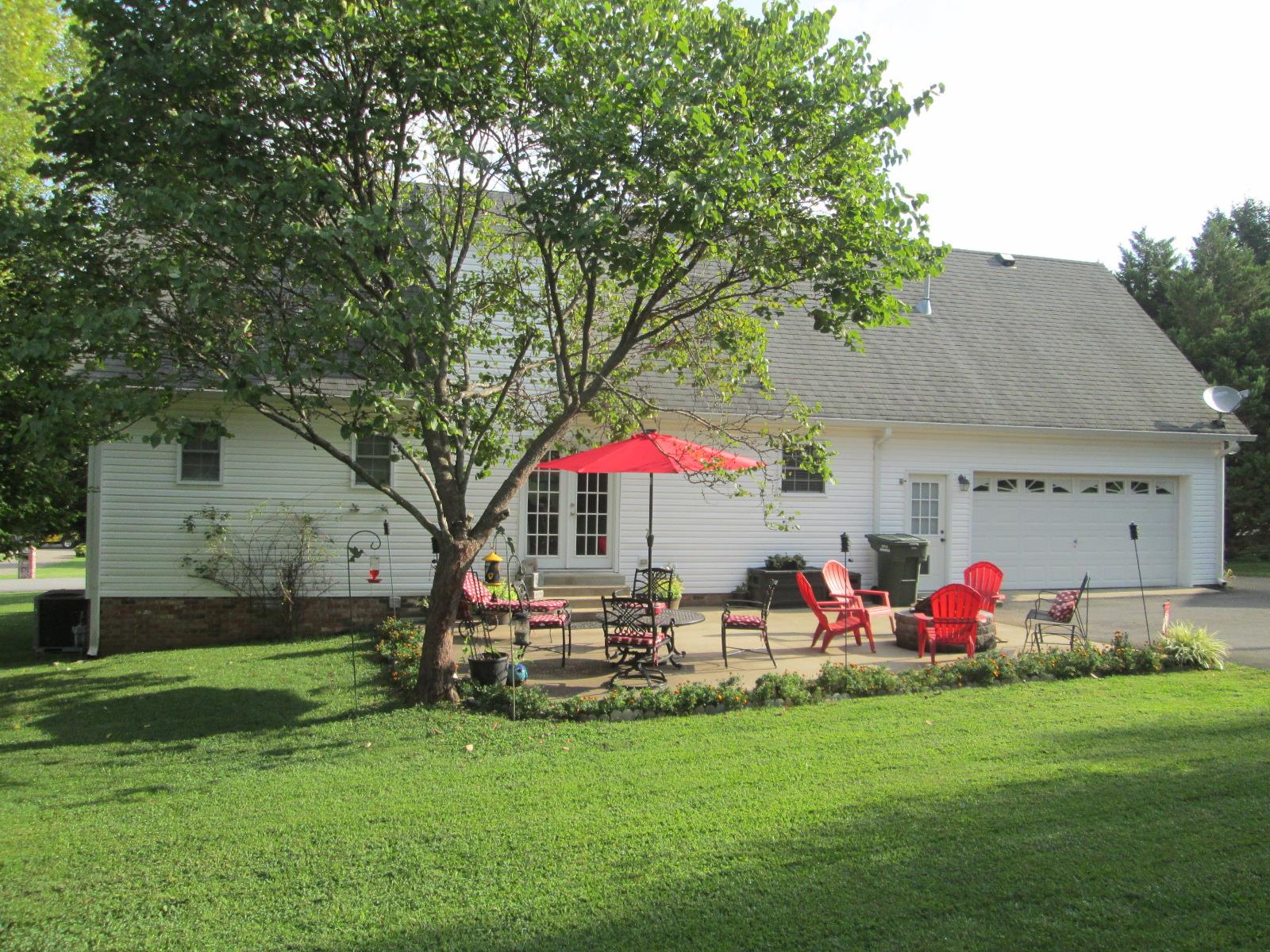 708 3rd Avenue West Springfield, TN 37172 - Photo 24 of 30 a view of patio with table and chairs under an umbrella