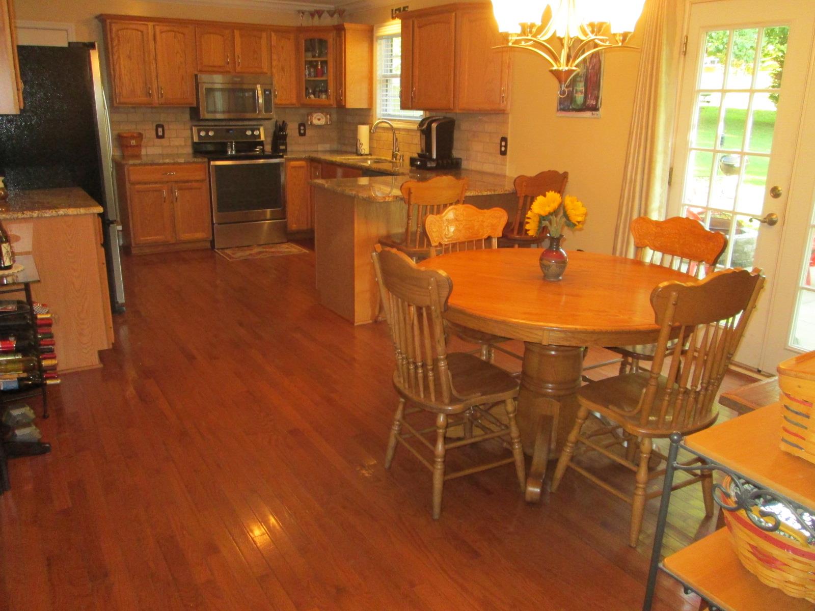 708 3rd Avenue West Springfield, TN 37172 - Photo 6 of 30 a dining room with stainless steel appliances a dining table and chairs