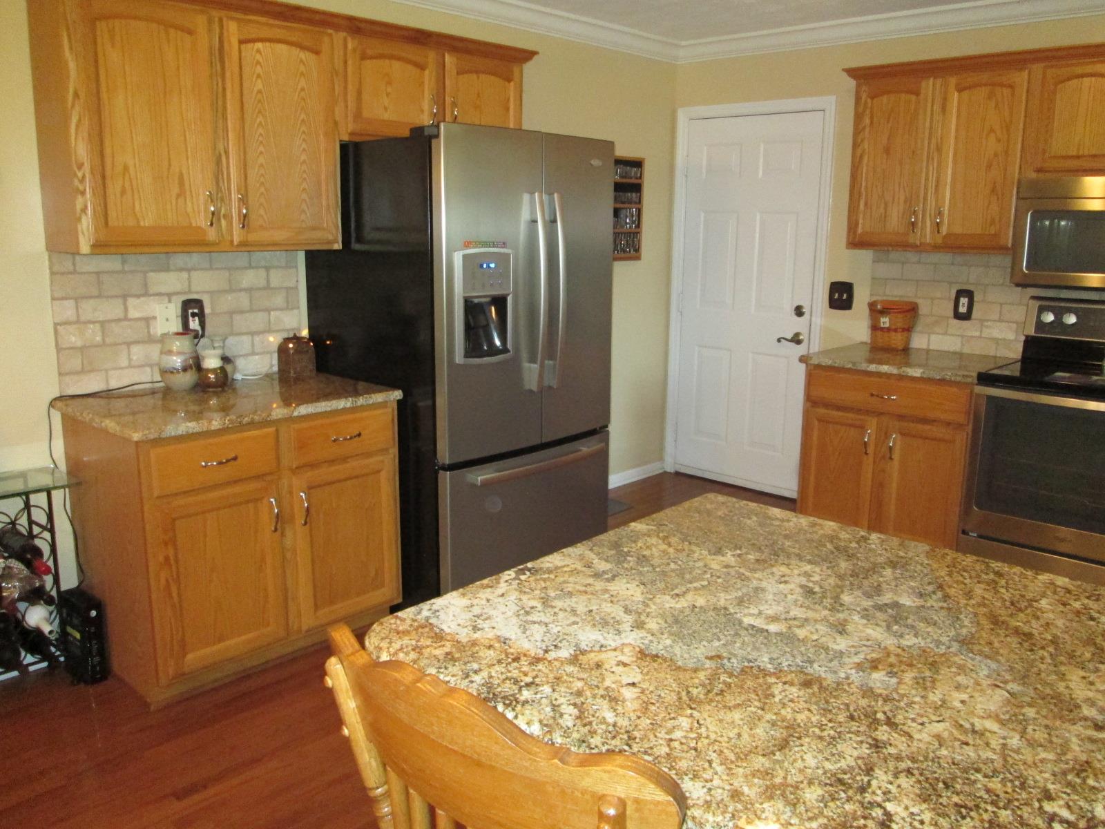 708 3rd Avenue West Springfield, TN 37172 - Photo 8 of 30 a kitchen with stainless steel appliances granite countertop a refrigerator sink and cabinets