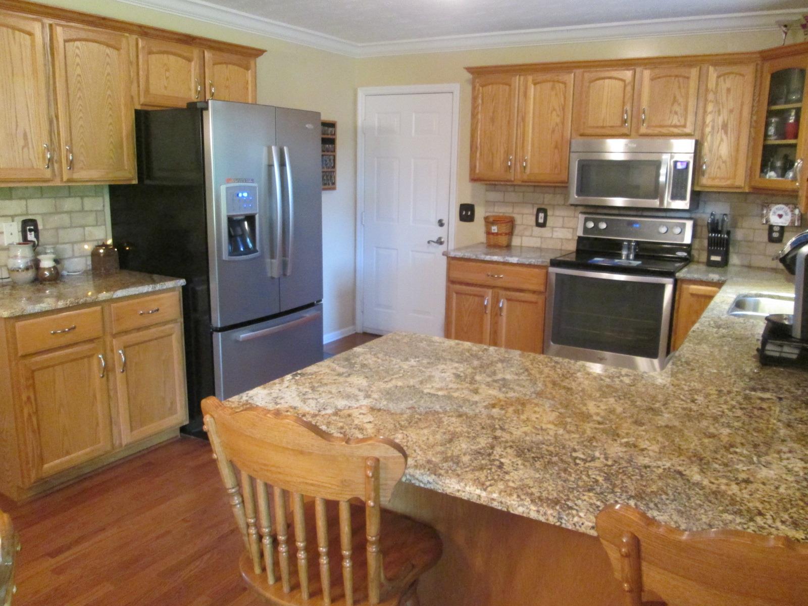708 3rd Avenue West Springfield, TN 37172 - Photo 9 of 30 a kitchen with stainless steel appliances granite countertop a refrigerator stove microwave and sink