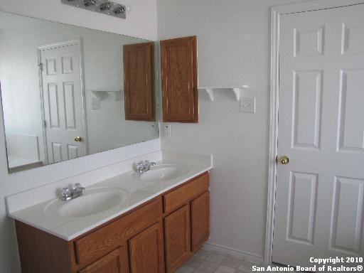 8026 Rio NIEBLA San Antonio, TX 78249 - Photo 11 of 15 a bathroom with a sink and a mirror