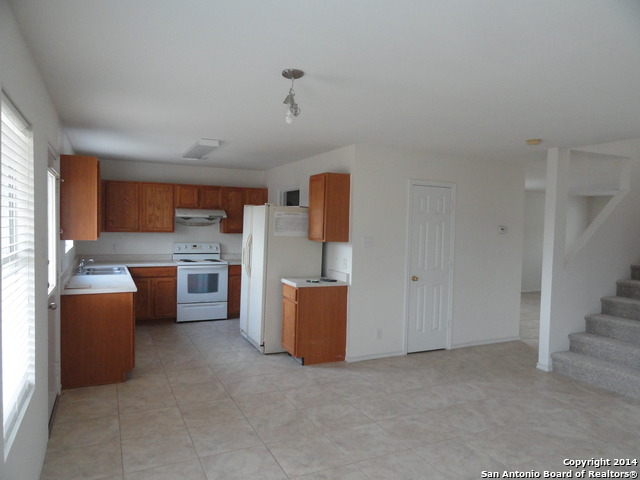 8026 Rio NIEBLA San Antonio, TX 78249 - Photo 4 of 15 a room with stainless steel appliances cabinets and a couch