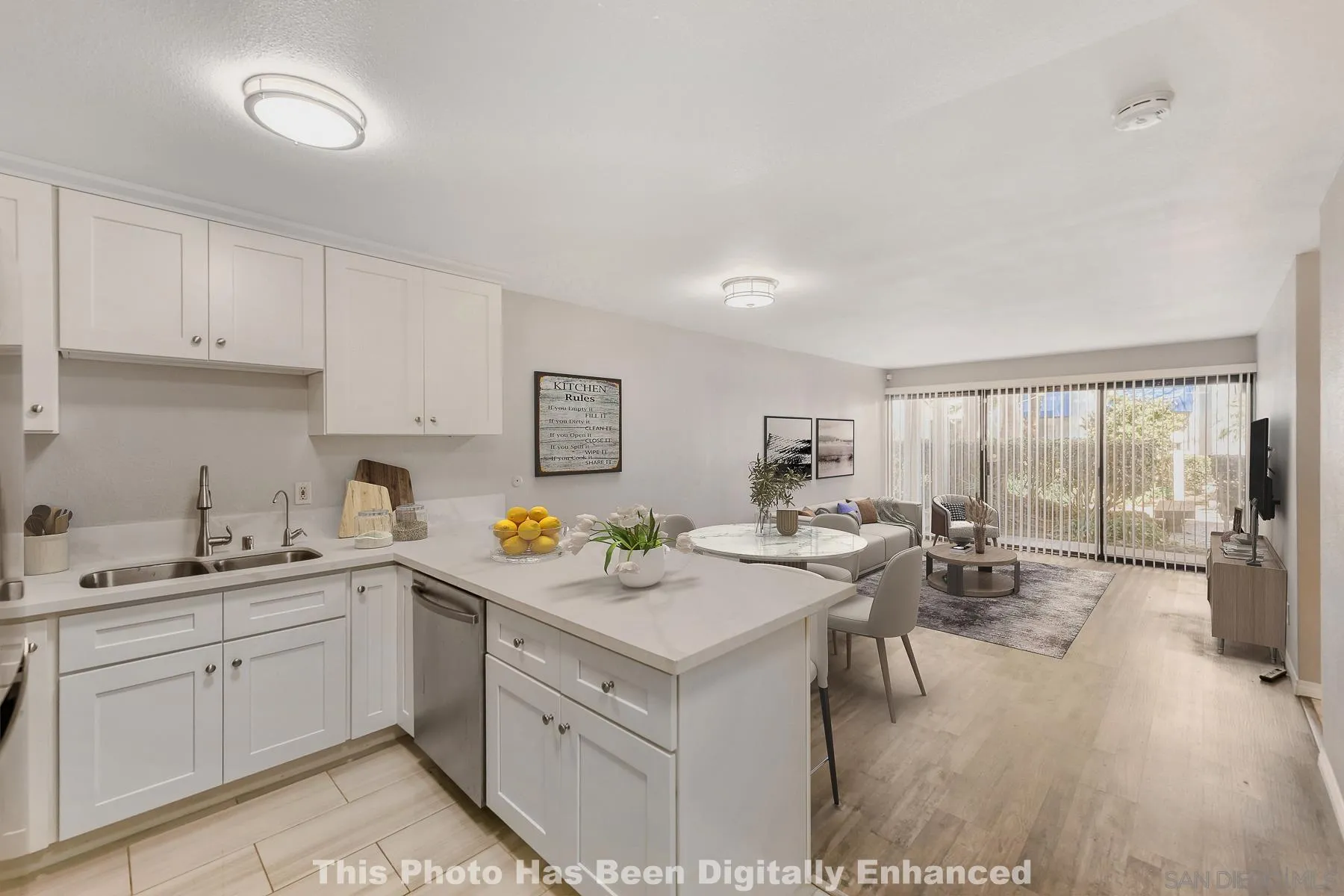 a view of a kitchen counter space a sink wooden floor and appliances