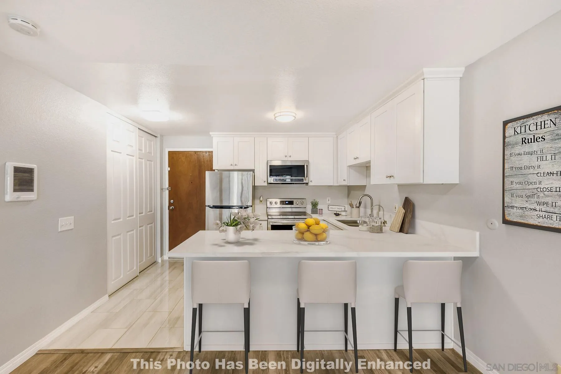 8308 Regents Road, Unit 1H San Diego, CA 92122 - Photo 2 of 23 a kitchen with stainless steel appliances a sink cabinets and wooden floor