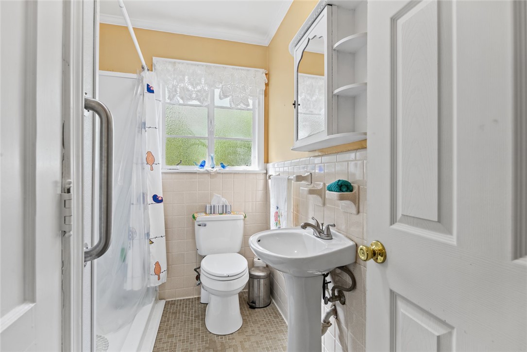 2028 Moultrie Square Anderson, SC 29621 - Photo 10 of 30 Classic tile wainscoting and a pedestal sink define this charming bathroom layout.