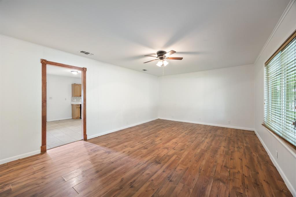 571 South 1st Street Point, TX 75472 - Photo 6 of 27 wooden floor in an empty room with a window