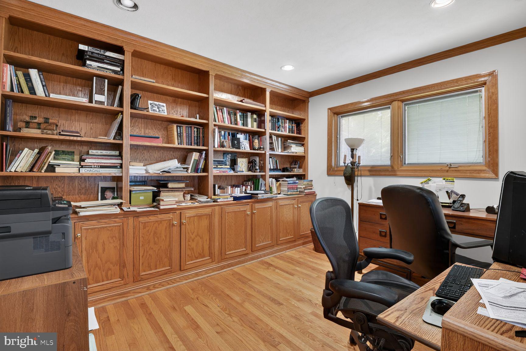 5800 Plainview Road Bethesda, MD 20817 - Photo 9 of 30 a view of a workspace with furniture and a bookshelf