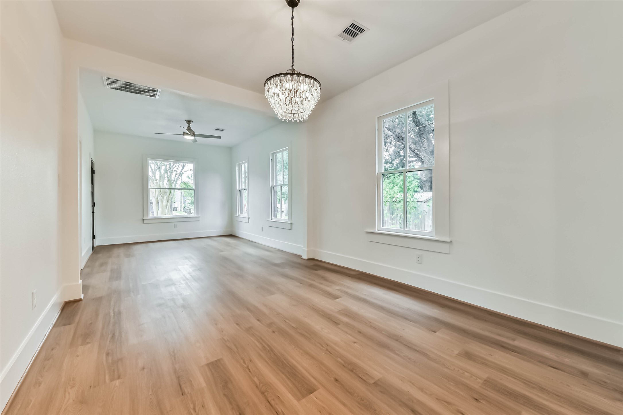 1616 38th Street Galveston, TX 77550 - Photo 11 of 26 an empty room with wooden floor and windows