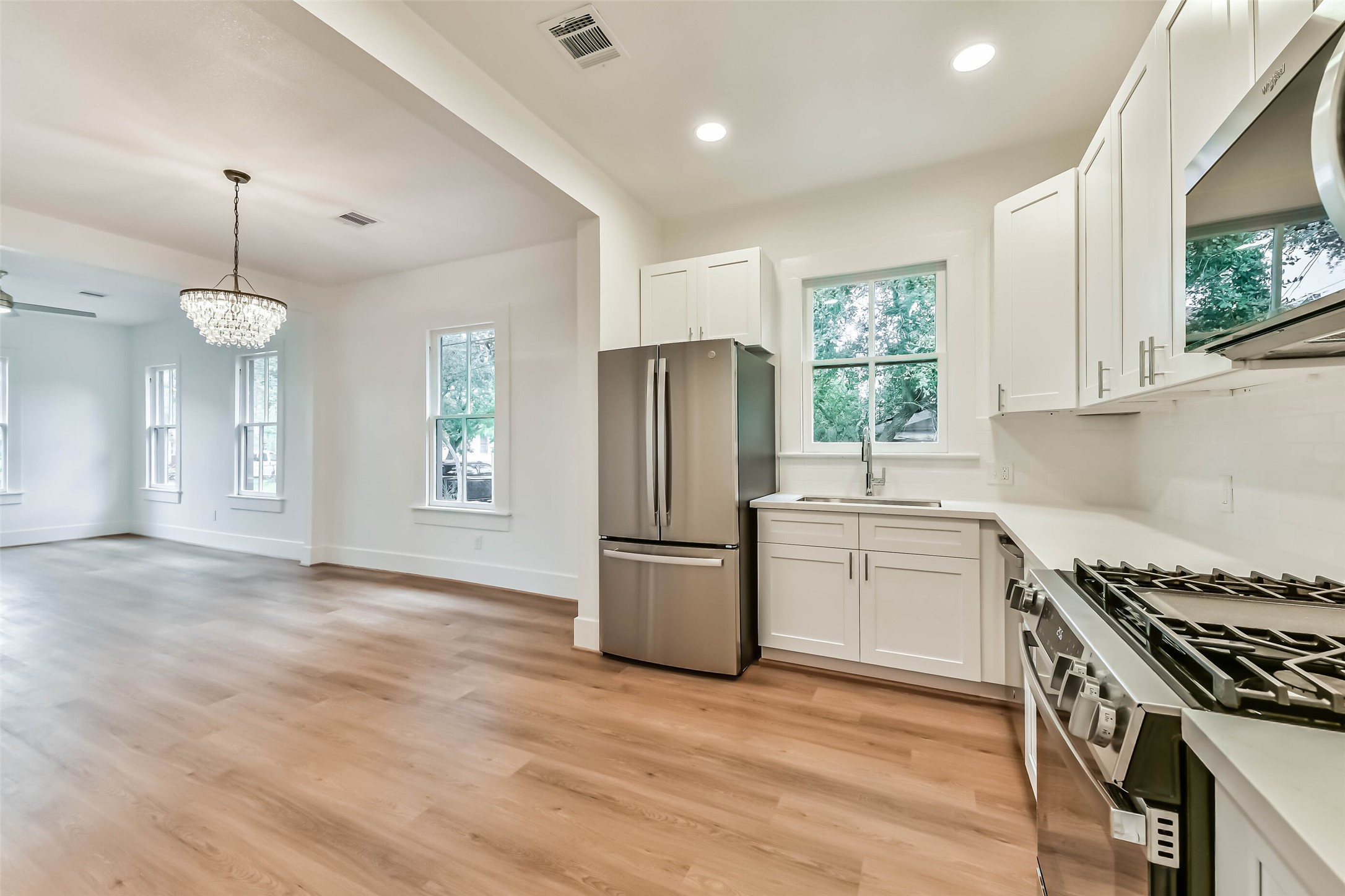1616 38th Street Galveston, TX 77550 - Photo 13 of 26 a kitchen with a stove a sink and a refrigerator