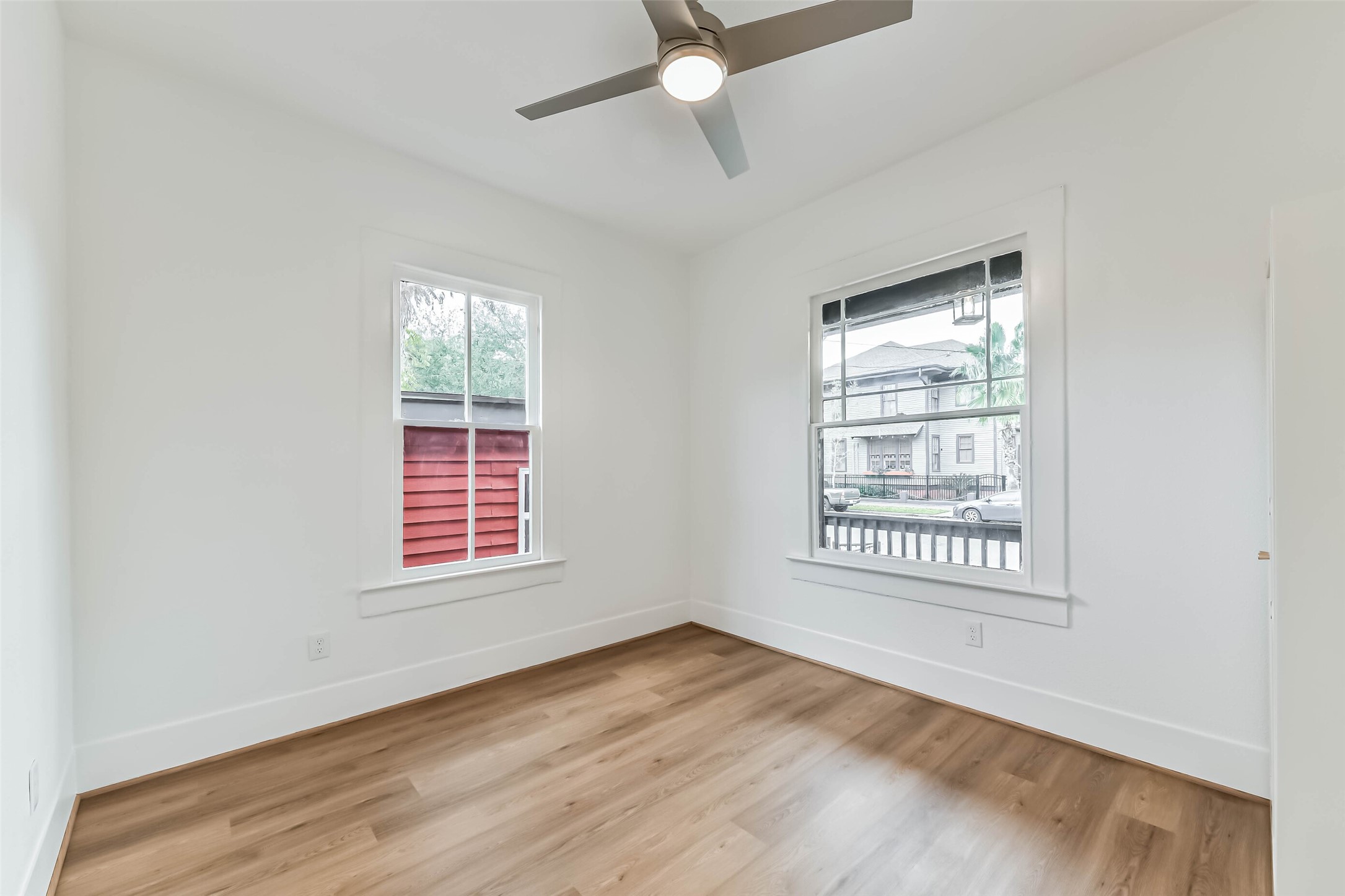 1616 38th Street Galveston, TX 77550 - Photo 18 of 26 an empty room with wooden floor fan and windows
