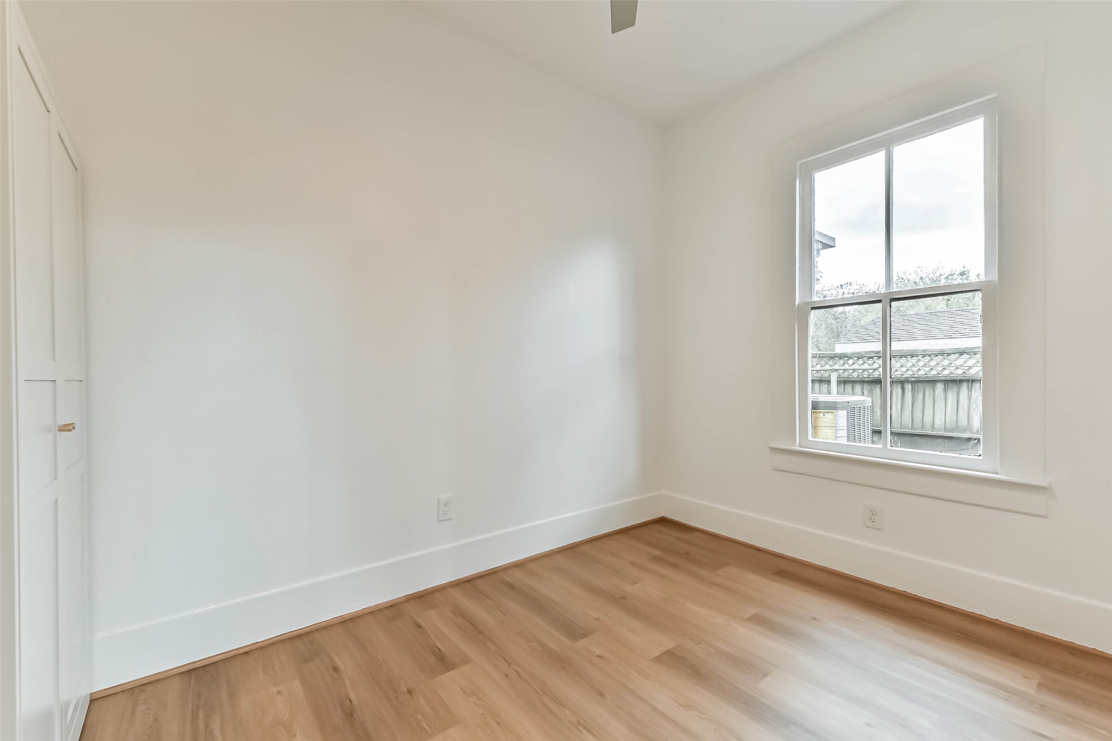 1616 38th Street Galveston, TX 77550 - Photo 22 of 26 an empty room with wooden floor and windows