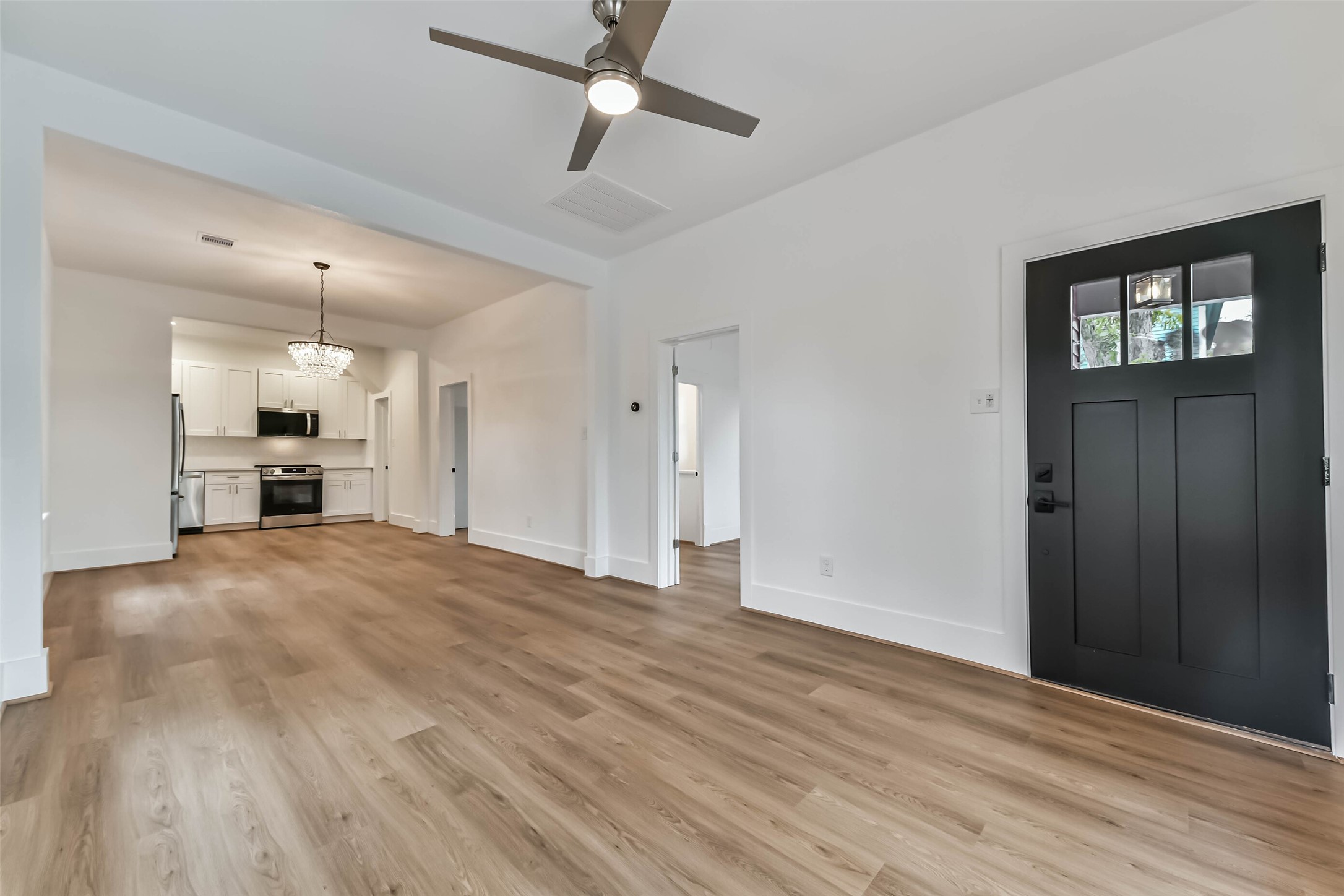 1616 38th Street Galveston, TX 77550 - Photo 7 of 26 a view of an empty room with a kitchen and a window