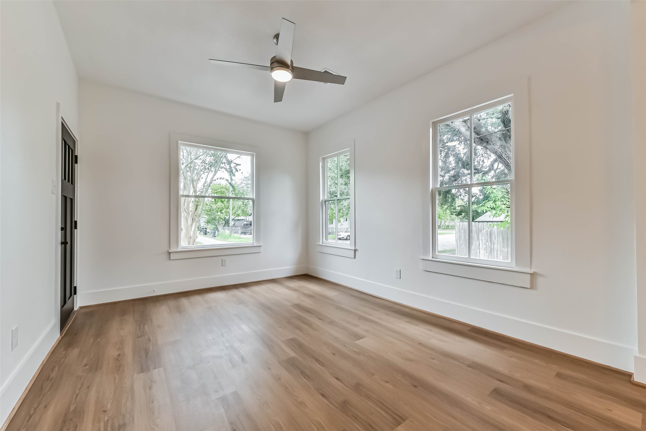 1616 38th Street Galveston, TX 77550 - Photo 8 of 26 a view of an empty room with wooden floor and a window