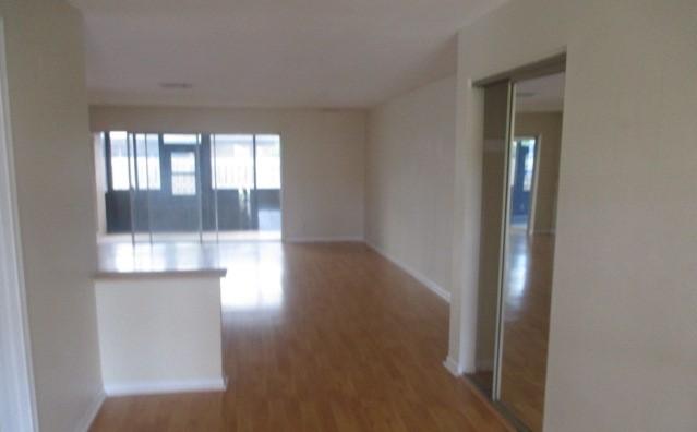 23097 Southwest 60th Way Boca Raton, FL 33428 - Photo 3 of 18 an empty room with wooden floor and windows