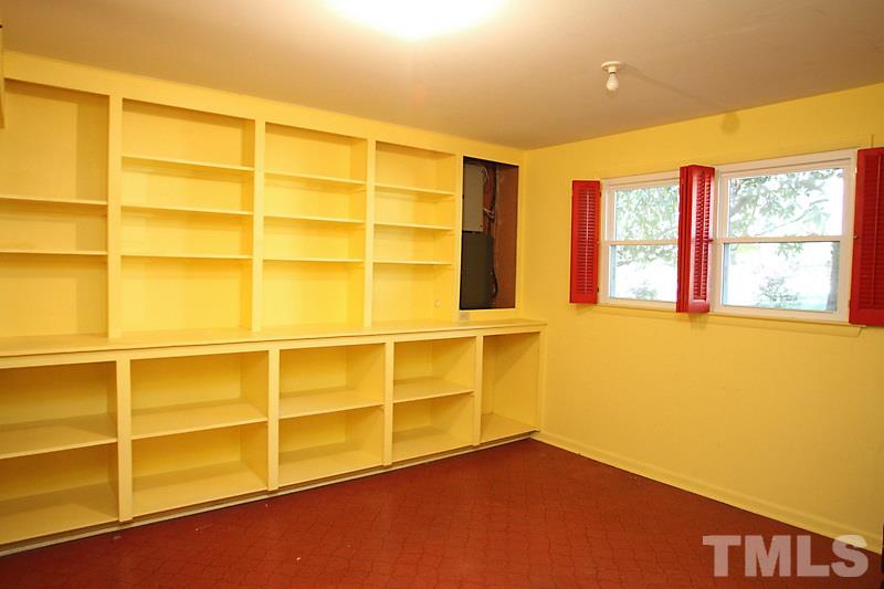 3208 Caldwell Drive Raleigh, NC 27607 - Photo 17 of 22 a view of an empty room with a window and wooden floor