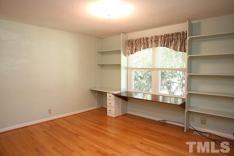 3208 Caldwell Drive Raleigh, NC 27607 - Photo 9 of 22 a view of an empty room with a window and wooden floor