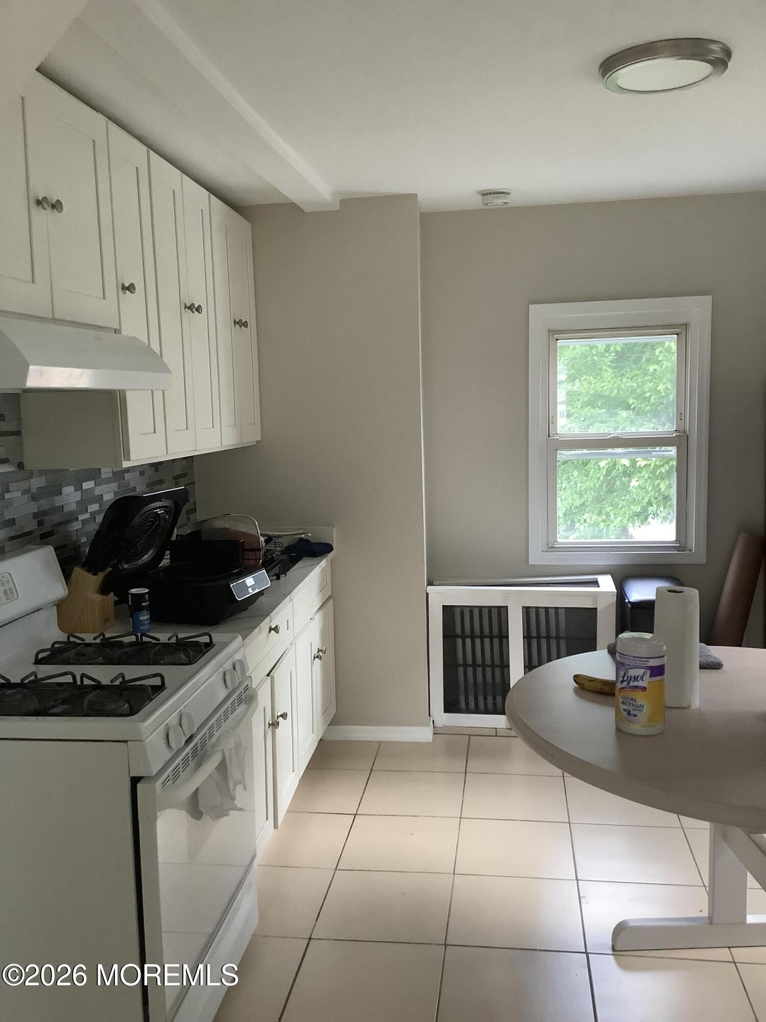 242 1st Street Keyport, NJ 07735 - Photo 10 of 23 a kitchen with a sink a stove and cabinets